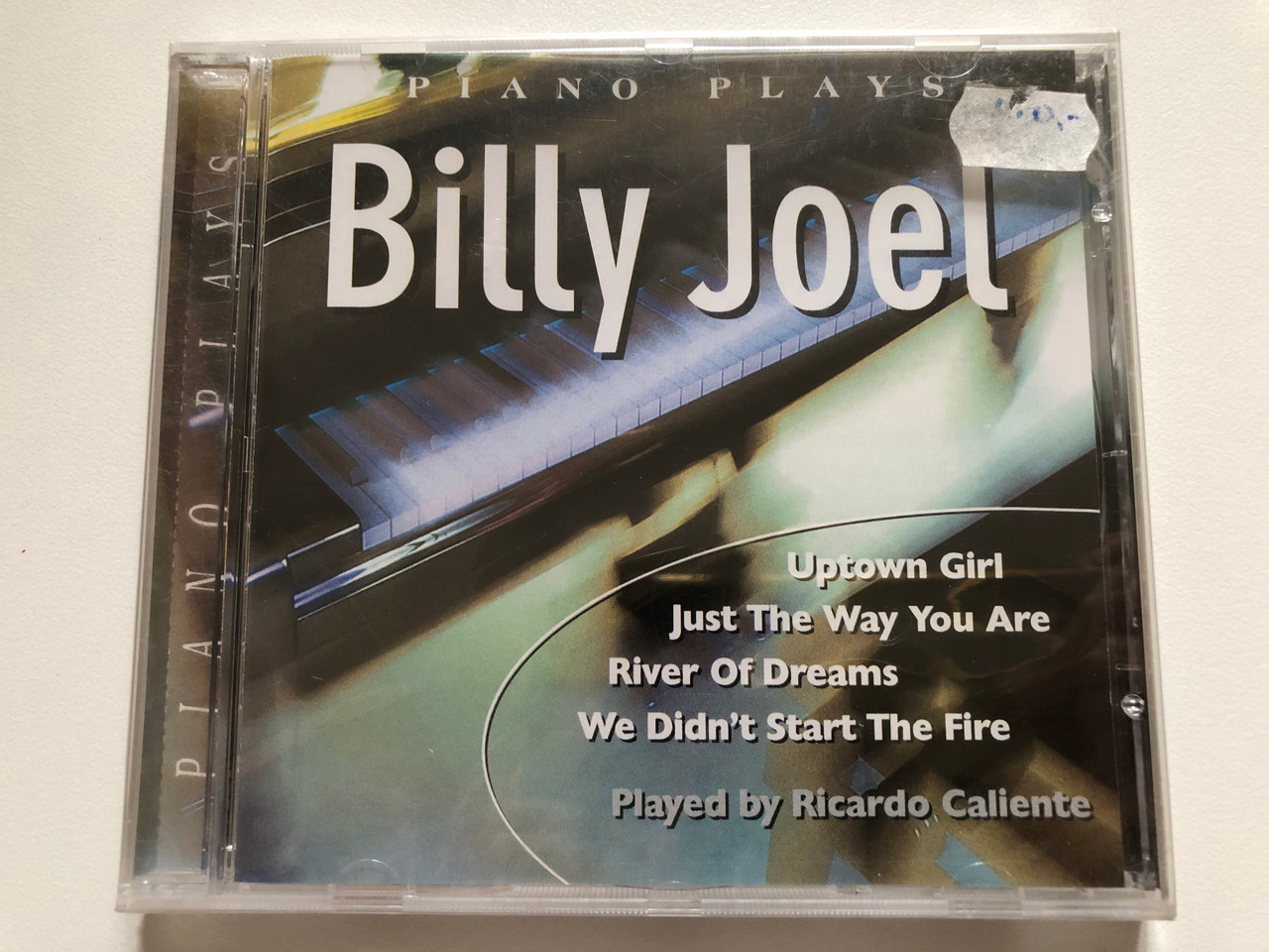 https://cdn10.bigcommerce.com/s-62bdpkt7pb/products/0/images/311285/Piano_Plays_Billy_Joel_-_Uptown_Girl_Just_The_Way_You_Are_River_Of_Dreams_We_Didnt_Start_The_Fire_-_Played_By_Ricardo_Caliente_Elap_Music_Audio_CD_1999_50485132_1__62037.1699550084.1280.1280.JPG?c=2