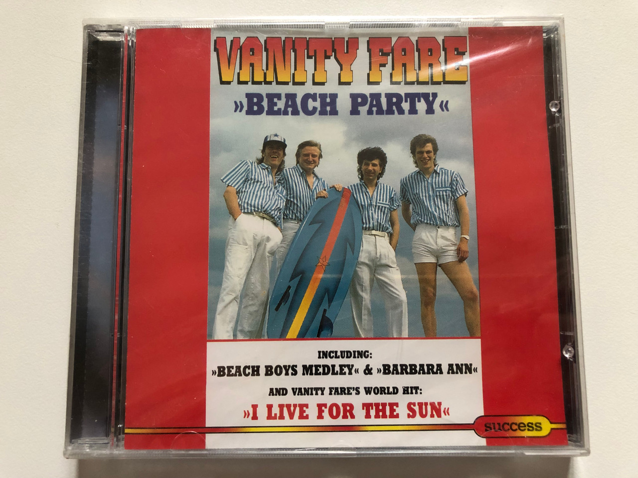https://cdn10.bigcommerce.com/s-62bdpkt7pb/products/0/images/311363/Vanity_Fare_Beach_Party_-_IncludingBeach_Boys_Medley_Barbara_Ann_And_Vanity_Fares_World_Hit_I_Live_For_The_Sun_Success_Audio_CD_1994_16198CD_1__28243.1699623417.1280.1280.JPG?c=2