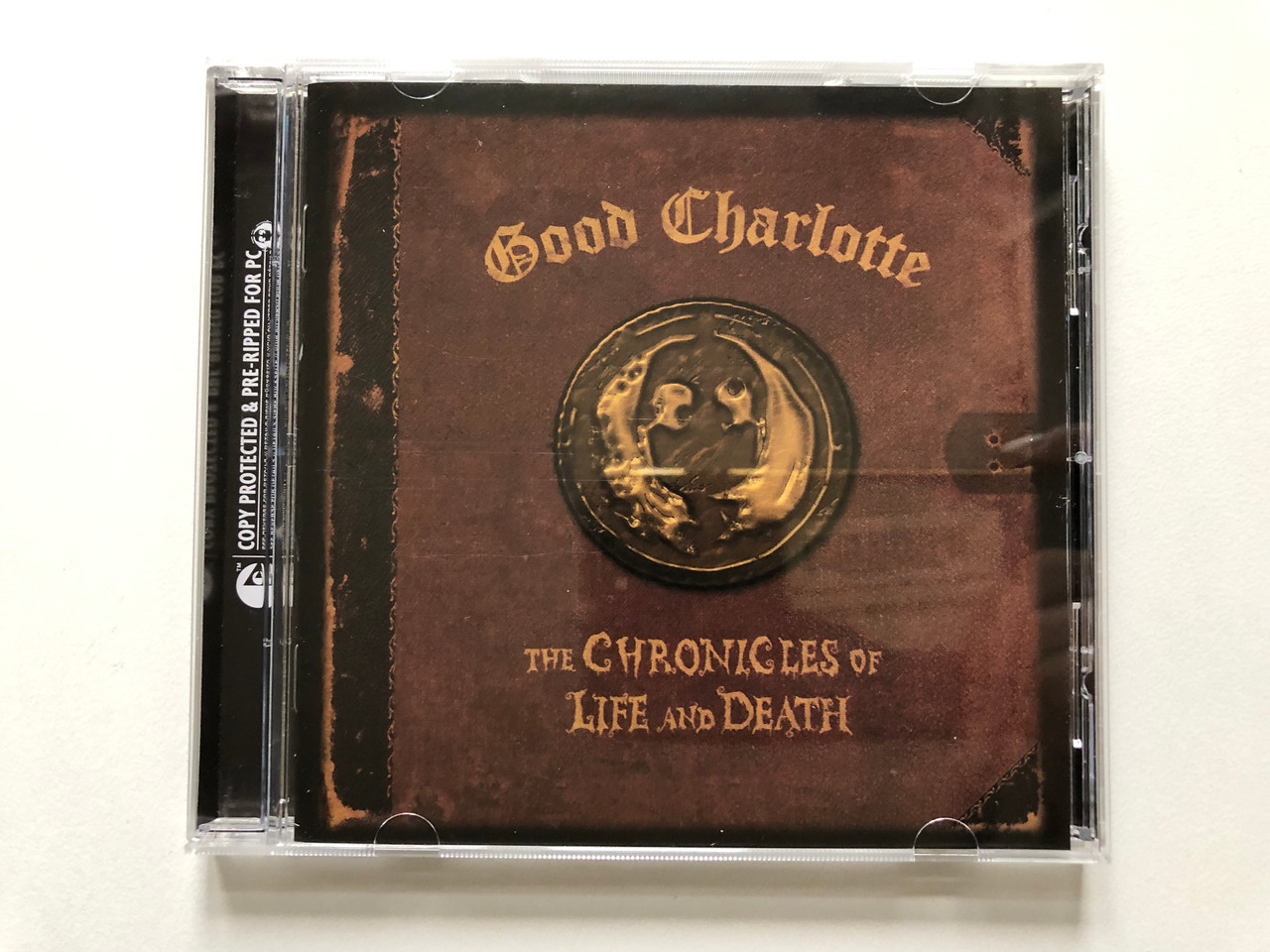 https://cdn10.bigcommerce.com/s-62bdpkt7pb/products/0/images/313415/Good_Charlotte_The_Chronicles_Of_Life_And_Death_Epic_Audio_CD_2004_517685_9_1__96080.1700758202.1280.1280.JPG?c=2