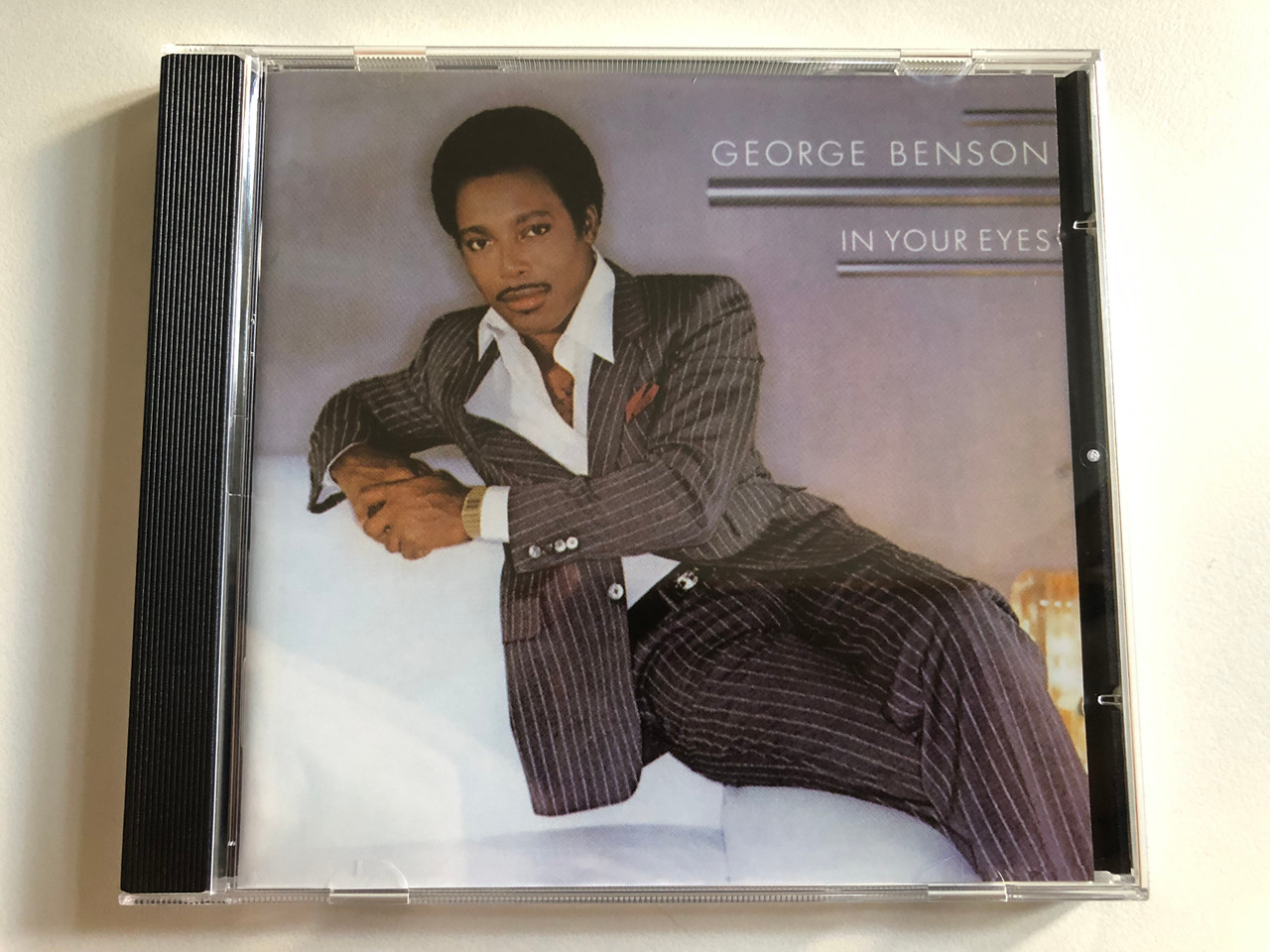 https://cdn10.bigcommerce.com/s-62bdpkt7pb/products/0/images/313487/George_Benson_In_Your_Eyes_Warner_Bros._Records_Audio_CD_7599-23744-2_1__90687.1700844364.1280.1280.JPG?c=2