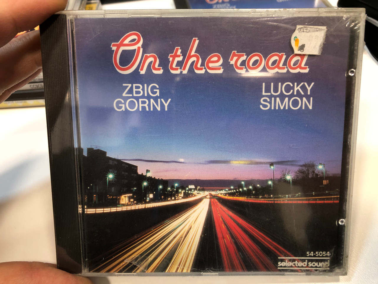 https://cdn10.bigcommerce.com/s-62bdpkt7pb/products/29441/images/175584/On_The_Road_-_Zbig_Gorny_Lucky_Simon_Selected_Sound_Audio_CD_1988_Stereo_54-5054_1__30570.1618816701.1280.1280.JPG?c=2&_ga=2.204831448.95372089.1618847256-1865802195.1618847256