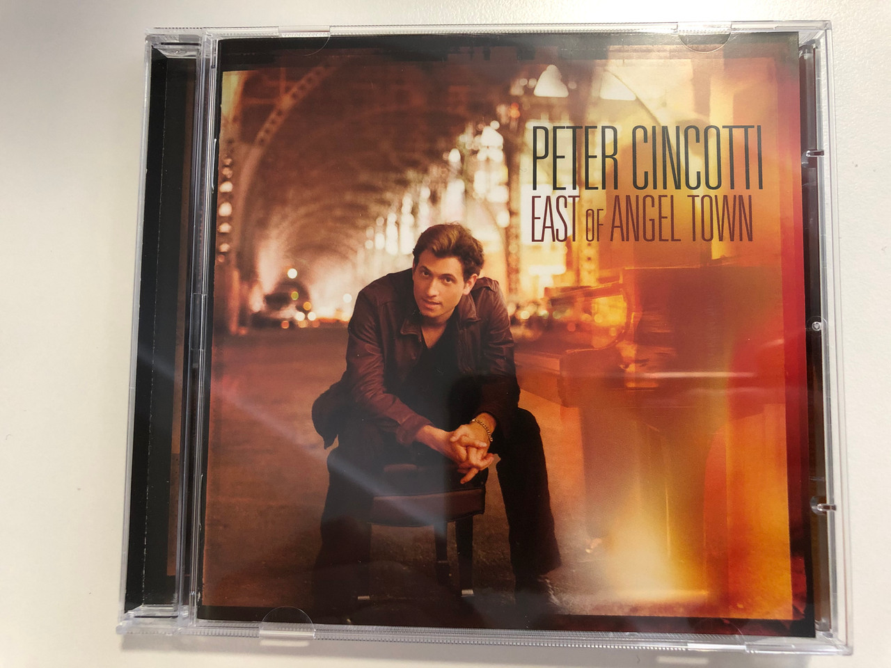 https://cdn10.bigcommerce.com/s-62bdpkt7pb/products/29859/images/177577/Peter_Cincotti_East_Of_Angel_Town_143_Records_Audio_CD_2007_9362-43286-2_1__11458.1620304300.1280.1280.JPG?c=2&_ga=2.112807108.1561355153.1620311476-427177752.1620311476