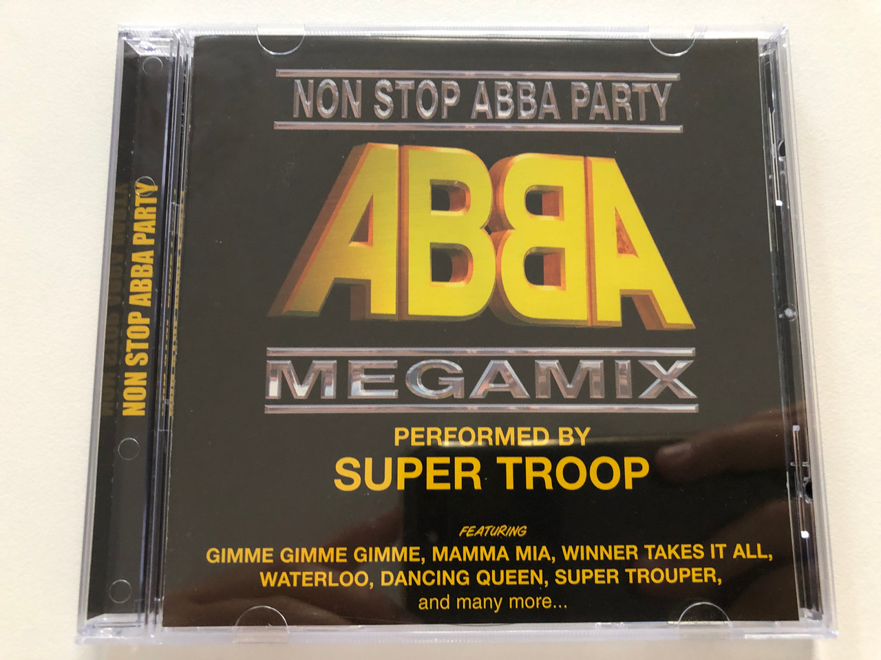 https://cdn10.bigcommerce.com/s-62bdpkt7pb/products/30922/images/182354/Non_Stop_Abba_Party_-_ABBA_Megamix_Performed_by_Super_Troop_Featuring_Gimme_Gimme_Gimme_Mamma_Mia_Winner_Takes_It_All_Waterloo_Dancing_Queen_Super_Trouper_and_many_more..._A-Play_Aud_1__83811.1624471263.1280.1280.JPG?c=2