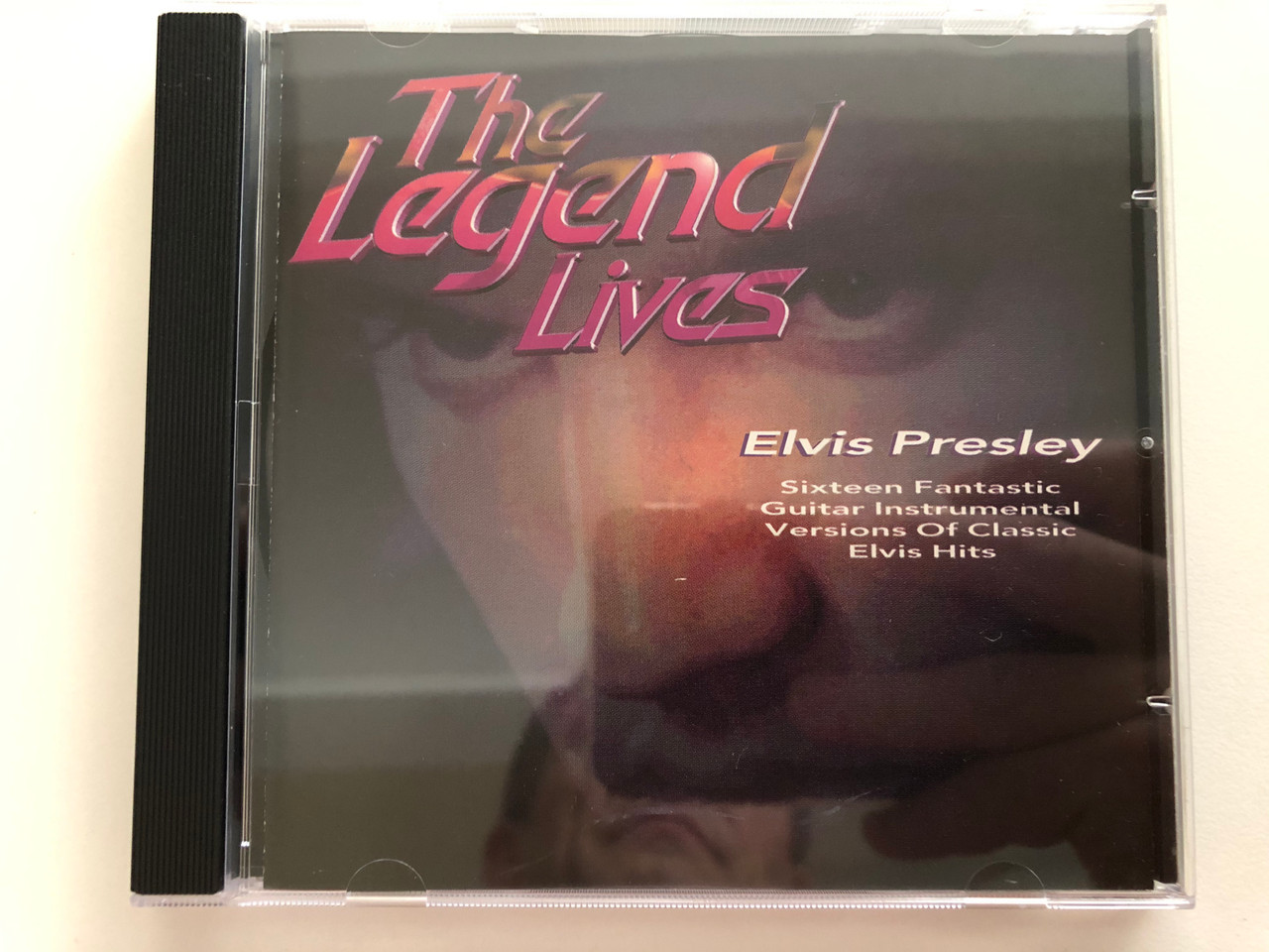 https://cdn10.bigcommerce.com/s-62bdpkt7pb/products/31103/images/183174/The_Legend_Lives_-_Elvis_Presley_Sixteen_Fantastic_Guitar_Instrumental_Versions_Of_Classic_Elvis_Hits_Hallmark_Audio_CD_1996_303702_1__45526.1625202049.1280.1280.JPG?c=2