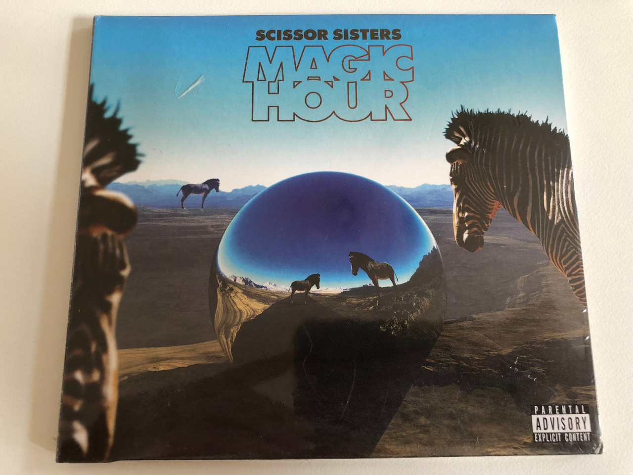 https://cdn10.bigcommerce.com/s-62bdpkt7pb/products/31425/images/184884/Scissor_Sisters_Magic_Hour_Polydor_Audio_CD_2012_3700441_1__26505.1626421231.1280.1280.JPG?c=2&_gl=1*1439arc*_ga*OTE2MzI1NzU5LjE2MjY0NjA3Nzg.*_ga_WS2VZYPC6G*MTYyNjQ2MDc3Ny4xLjEuMTYyNjQ2NzAyMS42MA..