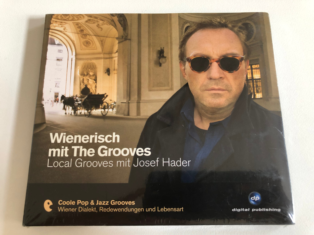 https://cdn10.bigcommerce.com/s-62bdpkt7pb/products/31429/images/184895/Wienerisch_Mit_The_Grooves_-_Local_Grooves_mit_Josef_Hader_Coole_Pop_Jazz_Grooves_Wiener_Dialekt_Radewendungen_und_Lebensart_Digital_Publishing_Audio_CD_2008_20_1__52567.1626424940.1280.1280.JPG?c=2&_gl=1*iis4ck*_ga*OTE2MzI1NzU5LjE2MjY0NjA3Nzg.*_ga_WS2VZYPC6G*MTYyNjQ2MDc3Ny4xLjEuMTYyNjQ2NTkwNC42MA..