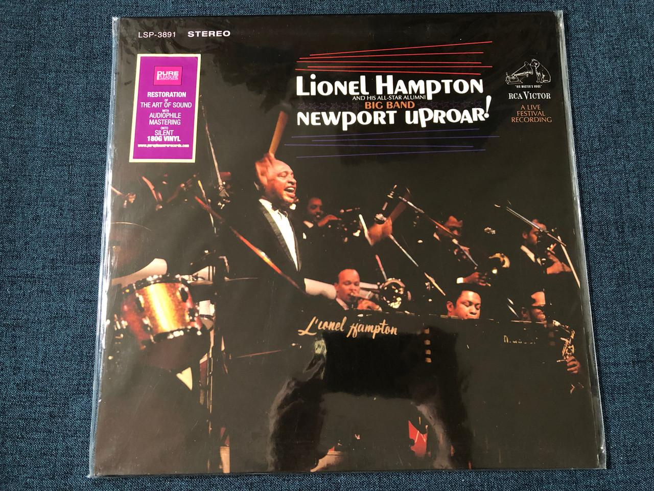 https://cdn10.bigcommerce.com/s-62bdpkt7pb/products/45831/images/243227/Lionel_Hampton_And_His_All-Star_Alumni_Big_Band_Newport_Uproar_Restoration_Of_The_Art_Of_Sound_With_Audiophile_Mastering_onto_Silent_180g_Vinyl_RCA_Victor_LP_Stereo_LSP-3891_1__06367.1658933820.1280.1280.JPG?c=2&_gl=1*282f8i*_ga*MjA2NTIxMjE2MC4xNTkwNTEyNTMy*_ga_WS2VZYPC6G*MTY1ODkyOTg1NC41MDAuMS4xNjU4OTMzOTI1LjU4