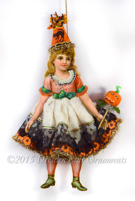Adorable Girl in Cotton Halloween Costume with Antique Paper and Pumpkin 