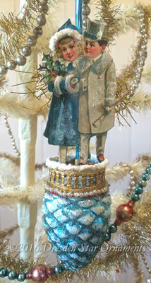 Wintery Boy an Girl on Light on Matching Blue Pinecone Ornament