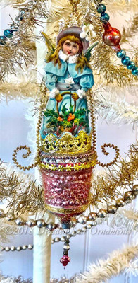 Snow Angel Wearing Chenille-Rimmed Blue Cloak in Elaborate in Antique Pink Molded Glass Basket  