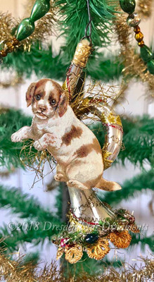 Adorable Spaniel Puppy on Free-Blown French Horn Decorated with Christmas Wreath