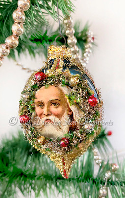 Santa Showcased Inside Decorated Wreath on Fancy Oval Indent Ornament