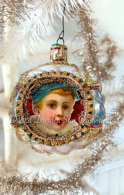 Boy with Blue Cap Tucked Inside Blue and White Frosted Indent Ornament