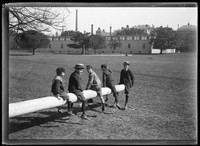 Boys seated on (telegraph) pole in the Domain looking to Sydney Hospital.