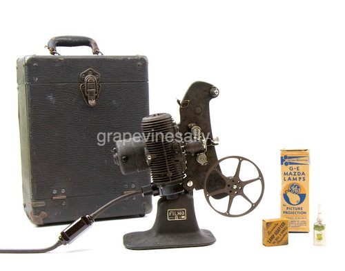 Working Vintage FILMO 8 Movie Projector. Everything pictured is included. 
Carrying Case Measurements: H 16.0" W 11.5" D 7.5"


