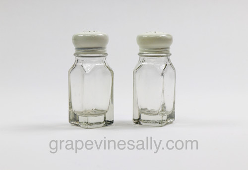 These are a great classic glass salt & pepper shaker set. There are no chips or cracks. One cap has a small dent. If you have a vintage themed space, these are a must! Pure functional eye candy.

MEASUREMENTS: Each Shaker - Height 4.0"" / Sides 1-1/2"