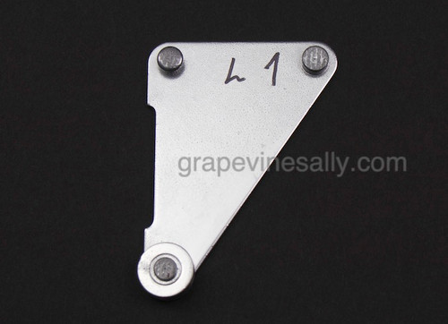 LEFT SIDE - Original 40's - 50's Vintage O'Keefe & Merritt Stove Oven Door Spring LEFT SIDE Pulley Guide Bracket. This bracket helps keep your main oven doors opening smoothly and evenly as you open and close the door. All rivets are in good shape and pulley  turn freely. 
