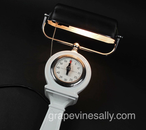 The Light & Timer Works.  The tic, tic, tic is quite noticeable and sounds like the opening of '60 Minutes' on CBS, the timer alarm sounds like the beginning alarm on Pink Floyd's song 'Time'; also quite noticeable.

This is a gorgeous re-conditioned vintage / antique stove top tall light and timer. The light has been re-wire with 16G high heat insulated wire. The light socket and bulb are new. The 60 minute timer works, and is absolutely fabulous. We have had this in our shop unrestored for at least 10 years and honestly we cannot remember what make of stove it started 'life' with - Magic Chef, Quick Meal, Wedgewood or ... There were several manufacturers that used these tall cast iron light/timers. They mounted on the center rear frame/backsplash. Unfortunately most went missing from the main stove over the years as people moved around the country. 

The timer face is original white lettered porcelain enamel, it is in great condition. No yellowing, chips or cracks. The body is heavy cast iron with beautiful white shiny original porcelain enamel. There are a couple of small light dents on the rear of the shade - not seen when mounted. Because the lamp support and shade is so fragile, we will ship this item in two pieces. The lamp frame and shade will be disconnected from the body. You will need to re-thread the two wires back through the lamp frame threaded connector that is on top of the timer area. Included will be 2' of additional wire leads. This is an extremely rare and hard to fine item is such gorgeous condition.

ALL MEASUREMENTS: 
Overall height / from base to top of light shade: 27.0"
Lower mounting plate black area: Height 5.0"  /  Width: 2-1/2"
Exposed main white porcelain enameled section only: Height: 17.0" 
Width of area at round timer: 5-1/2"
Light shade: Width 8-1/2"  /  Height 3-1/2"
Outermost light shade frame: 10-1/4"