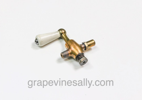 LIMITED SUPPLY - Vintage 1920's-30's Gas Stove Brass Burner Valve w/ White Ceramic Handle. This style burner valve was used by various period stove manufacturers. The white creramic handle is in very nice clean condition. There are no chips or cracks - the valve turns smoothly. The orifice caps are screwed down, they will need to be adjusted to the user's cooking preference. If you are not familiar with the fuel adjusting process we recommend that you contact a NG/LP professional in your area.
