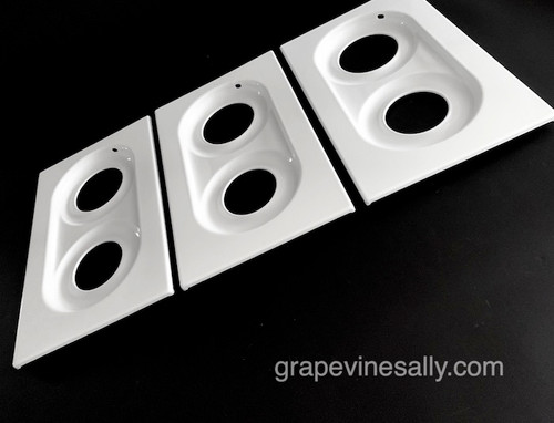 PLEASE READ FULL DESCRIPTION.
 
PLEASE NOTICE: This set has the square outer corners, NOT the 1/4 round outer corners that are found on other 1940's-50's vintage Wedgewood stoves top panels.
 
FULL SET of 3 Stove Tops - These fit the vintage 40" Wedgewood 6 burner stove. This is a very nice used porcelain enamel stove top set. This is one of the nicest use porcelain enameled sets we've seen.  The metal integrity on all three panel is excellent - as with any used set there is a very small surface rust in a couple of area, but nothing that has damage the steel. See the last photo. We have touched up the a few small areas, not noticeable when they are installed. The porcelain enamel is bright and shiny, all pieces have been thoroughly cleaned and polished - this is the only 6 burner complete set we have at this time in porcelain enamel. The last couple of photos show these tops with new porcelain enameled arrow double Wedgewood grates - the grate is for demonstration purposes only and is not included in this listing. 

These accommodate the 8.0" wide Wedgewood grate (measure the outer edges of the horseshoe ring)
 
PANEL MEASUREMENTS: Each Panel is 20-1/2" D x 12-1/4" W 
 
 
Add a set of new PE grates (in the store) and you'll have a beautiful new looking stove.
 
Call with any questions - we're happy to help.