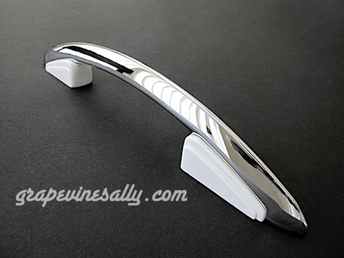 Original NEW CHROMED Vintage Western Holly Gas Stove 11" Oven Door & Drawer Handle. The white plastic/bakelite trim is bright white and shiny. Original mounting gasket is included. In addition to the new chrome, this handle has been completely disassembled and reconditioned. Like new condition. Fits the vintage 1940's - 1950's Western Holly Mid-Century Stoves. These handles are an extremely rare find.

MEASUREMENTS: Overall Length - 11.0" / Screw Mounting Holes - 5.5" (on center)