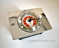 THIS CLOCK WORKS

Original Vintage 1940's-50's O'Keefe & Merritt Gas Stove Built-In New Chrome Clock w/ 4 Hour Cooking Timer.

Includes new high heat insulated 16G wire, 1' of ultra high heat wire sleeving (not pictured).

This is a great vintage O'Keefe & Merritt gas stove clock/cooking 4 hour timer. This clock/timer sits built-in the center of your stove backsplash. The exterior chrome trim plate is NEW CHROME. The clock bezel ring has been re-conditioned, it is in very nice condition. The glass crown has no cracks, chips or scratches. The clock/timer faceplate finish is bright red an in good condition, the white plastic knobs turn as intended. 

This is a gorgeous clock.
 
MEASUREMENTS: Black Box 4-1/4" w x 3-5/8" H
 
All of our new chromed stove parts are 'Triple Plated' (copper, nickel, chrome).
