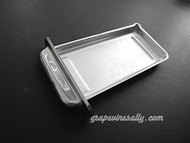 Vintage 1940's-1950's O'Keefe & Merritt Gas Stove used chrome center griddle grease drip tray. The chrome pull is bright and shiny on the exposed areas, the underside side has wear and exposed copper. This is in very nice used condition. MEASUREMENTS: 9-7/8 x 4-5/8
