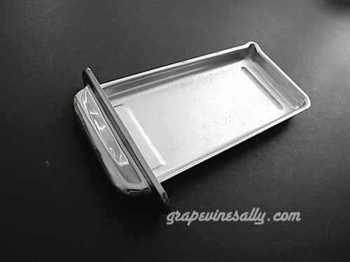Vintage 1940's-1950's O'Keefe & Merritt Gas Stove used chrome center griddle grease drip tray. The chrome pull is bright and shiny on the exposed areas, the underside side has wear and exposed copper. This is in very nice used condition. MEASUREMENTS: 9-7/8 x 4-5/8