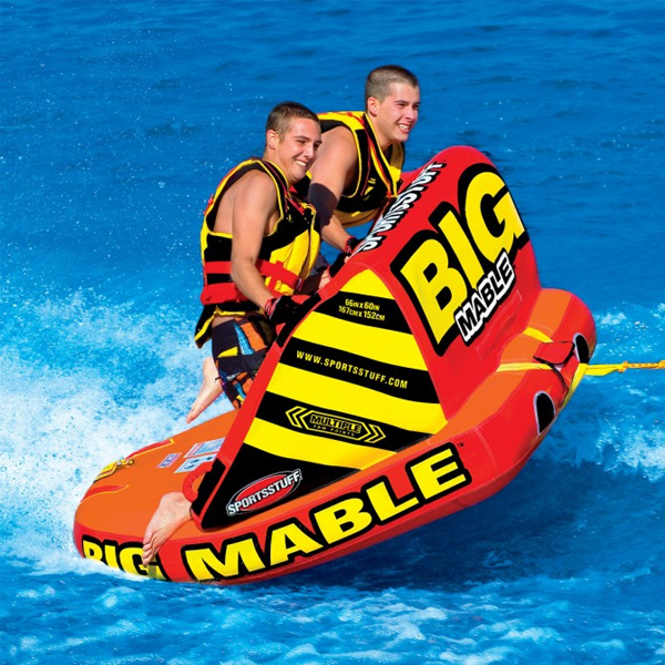 Happy people riding on boat tube