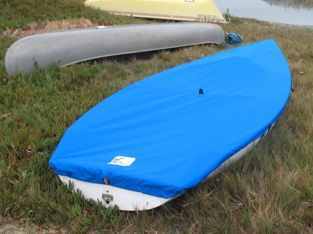 Sailboat Top Deck Cover to fit a Hobie® One 12 made in America by skilled artisans at SLO Sail and Canvas. 1/4" shockcord is built into cover to secure your cover tightly around the boat's rubrail. Web Loops allow you to “tent” your cover up to prevent pooling of water. 


