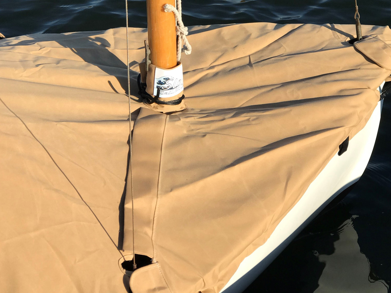 Mooring Cover by SLO Sail and Canvas. A mast collar and perfectly placed shroud cutouts fit tightly around your boat’s rigging. 
