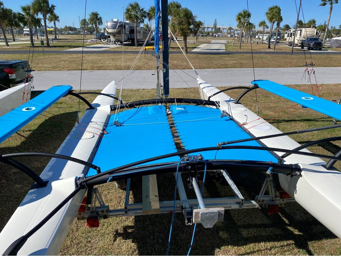 Trampoline to fit a Hobie® 21 SE catamaran - made in America by skilled artisans at SLO Sail and Canvas. Hand pounded #4 brass spur grommets. (2) 12” X 12” halyard pockets, included. Made with Textilene 90 PVC coated 1000 denier Polyester mesh, and your choice of thread.