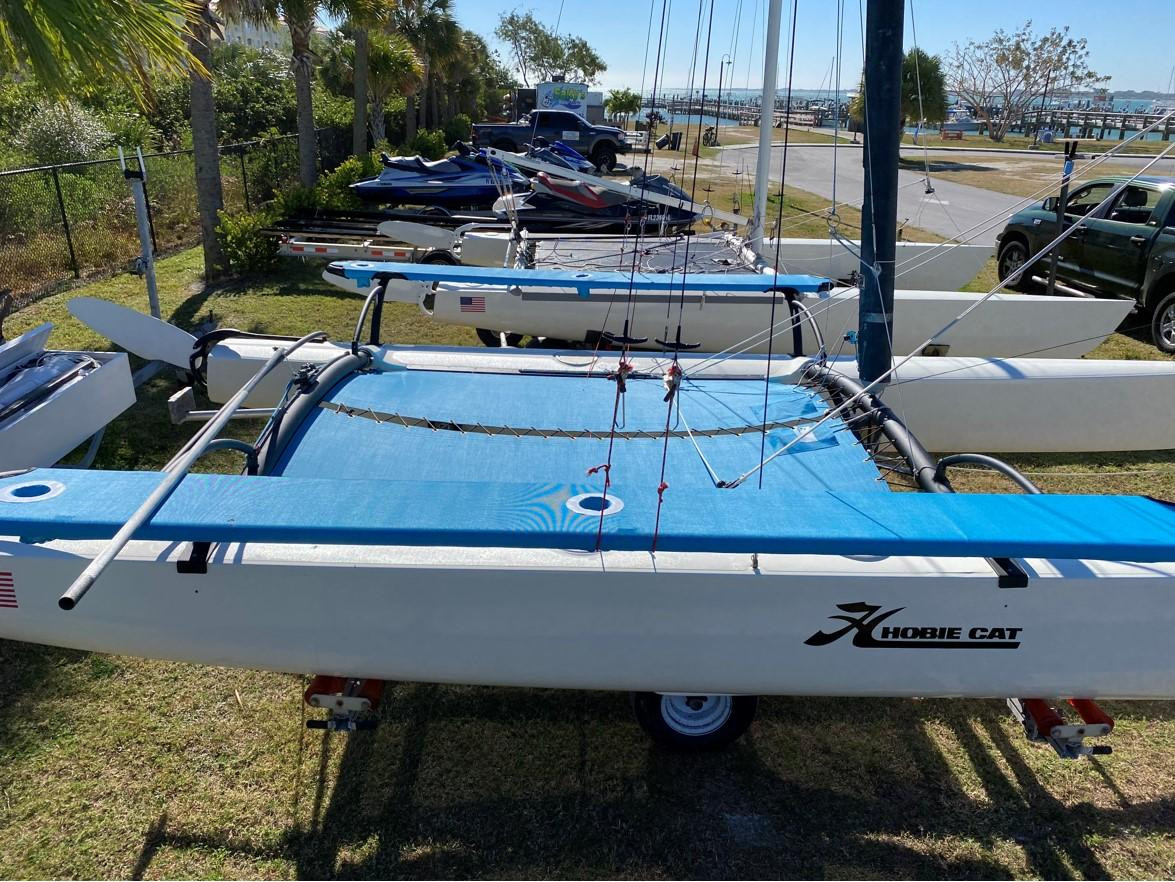 Trampoline to fit a Hobie® 21 SE catamaran - made in America by skilled artisans at SLO Sail and Canvas. Hand pounded #4 brass spur grommets. (2) 12” X 12” halyard pockets, included. Made with Textilene 90 PVC coated 1000 denier Polyester mesh, and your choice of thread.