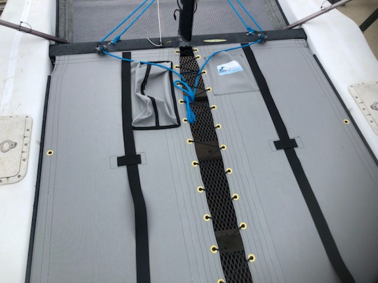 2pc Trampoline to fit a Hobie Getaway catamaran made in America by skilled artisans at SLO Sail and Canvas. 12” X 12” halyard pocket, included. Hand pounded #4 brass spur grommets. Adjustable hiking straps made of 3” Polypropylene webbing. Shown in Textilene 90 Dusk Grey premium mesh. Optional Upgrade: Zipper Pocket shown.