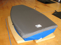 Naples Sabot Sailboat Top Cover made in America by skilled artisans at SLO Sail and Canvas. 1/4" shockcord is built into cover to secure your cover tightly around the boat's rubrail. Webbing loops are sewn around the perimeter of our top covers allowing your cover to be tied to your boat. All of our covers are patterned from the actual boats they are designed to fit. This make for a better, higher quality product.


