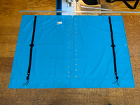 Nacra 18 Square catamaran trampoline with center lace. Made in America by skilled artisans at SLO Sail and Canvas. Adjustable hiking straps made of 3” Polypropylene webbing. Built-in aft line catcher, included. Hand pounded #4 brass spur grommets. 12” X 12” halyard pocket, included. 