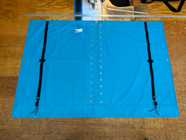 Nacra 18 Square catamaran trampoline with center lace. Made in America by skilled artisans at SLO Sail and Canvas. Adjustable hiking straps made of 3” Polypropylene webbing. Built-in aft line catcher, included. Hand pounded #4 brass spur grommets. 12” X 12” halyard pocket, included. 