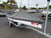 Melges 15 Mast Up Peaked Mooring Cover by SLO Sail and Canvas. 1/4" shockcord is built into cover to secure your cover tightly around the boat's rubrail. Web Loops allow you to “tent” your cover up to prevent pooling of water. A mast collar and perfectly placed shroud cutouts fit tightly around your boat’s rigging. 
