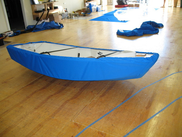 Sailboat Hull Cover made in America by skilled artisans at SLO Sail and Canvas. 1/4" shockcord is built into cover to secure your cover tightly around the boat's rubrail. Polypropylene straps with plastic Fastex buckles included.