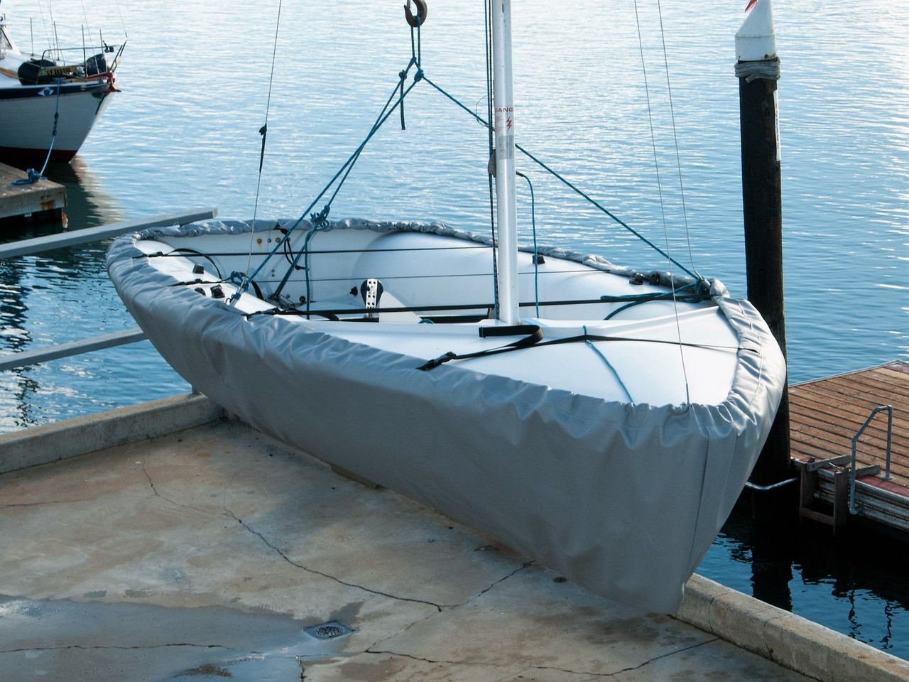 Sailboat Hull Cover by SLO Sail and Canvas. 1/4" shockcord is built into cover to secure your cover tightly around the boat's rubrail. Straps with plastic Fastex buckles included.
