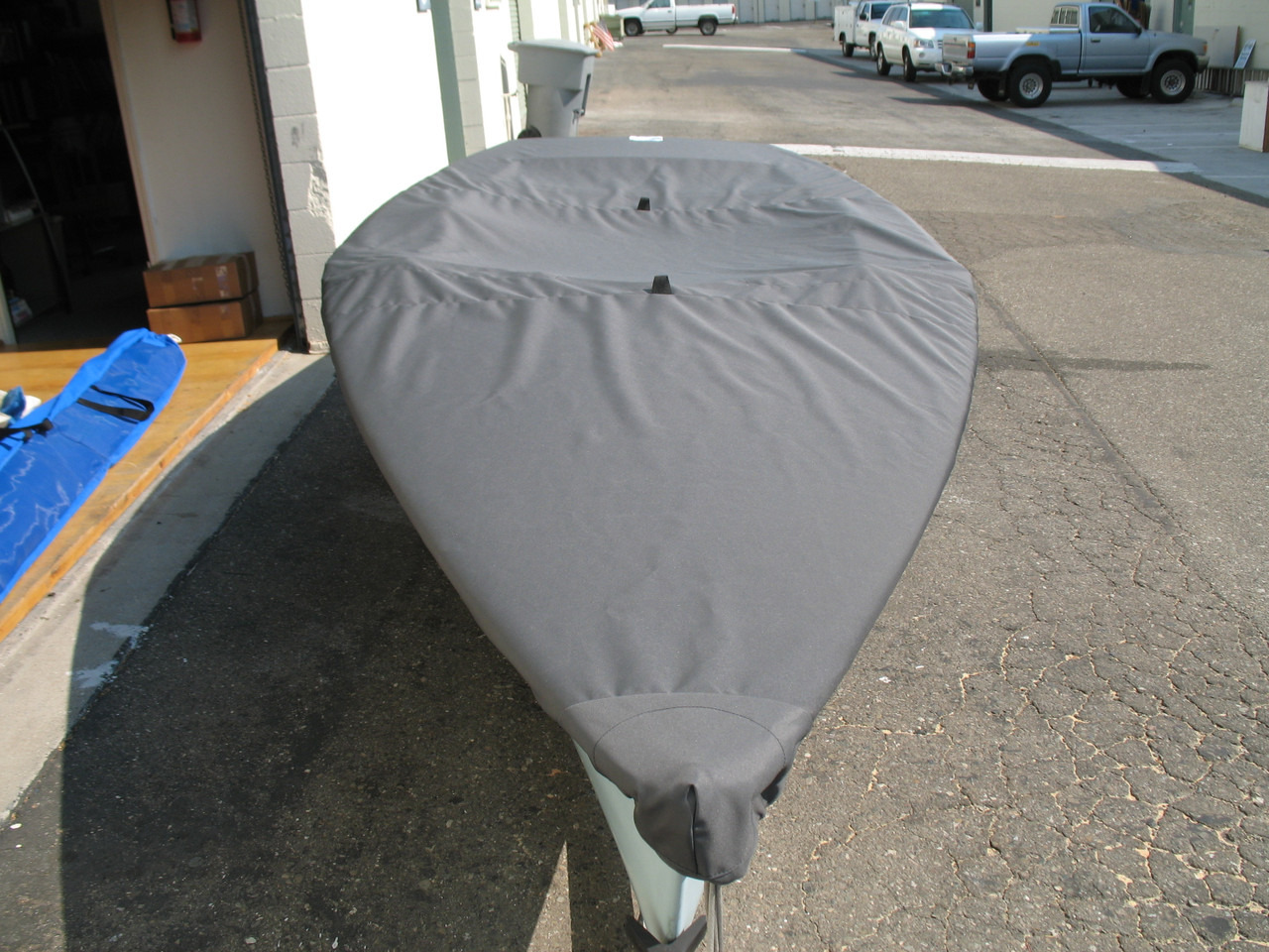 Tasar Deck Cover by SLO Sail and CanvasWeb Loops allow you to “tent” your cover up to prevent pooling of water. 
