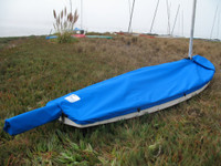 Sunfish Mast Up Flat Cover made in America by skilled artisans at SLO Sail and Canvas.  1/4" shockcord is built into cover to secure your cover tightly around the boat's rubrail. Webbing loops are sewn around the perimeter of our top covers allowing your cover to be tied to your boat. A mast collar fits tightly around your boat’s mast. All of our covers are patterned from the actual boats they are designed to fit. This make for a better, higher quality product.

