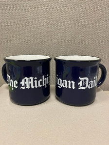 Hand wash only. Enjoy your favorite coffee, tea, or hot cocoa in what will soon be your new favorite mug. The Michigan Daily 15 oz. ceramic mug comes in two options: a navy glossy exterior with glossy white interior and matte black distressed finish, or white glossy exterior with white interior, navy lettering, and matte black distressed finish.