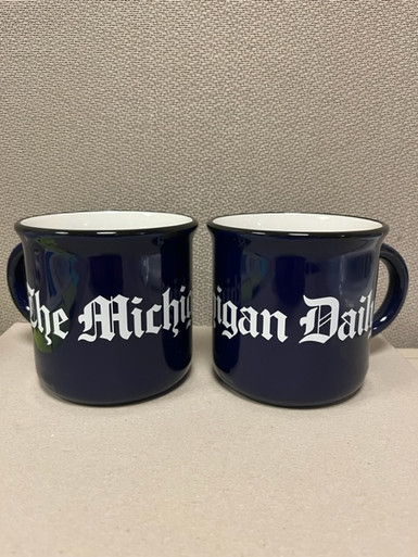 Hand wash only. Enjoy your favorite coffee, tea, or hot cocoa in what will soon be your new favorite mug. The Michigan Daily 15 oz. ceramic mug comes in two options: a navy glossy exterior with glossy white interior and matte black distressed finish, or white glossy exterior with white interior, navy lettering, and matte black distressed finish.