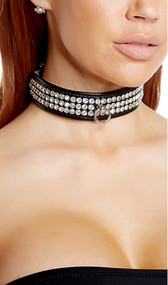 Faux leather choker with rhinestone detail and o ring. Adjustable buckle closure.
