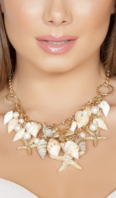 Shell necklace with beaded starfish and faux pearl accents with adjustable lobster clasp closure.