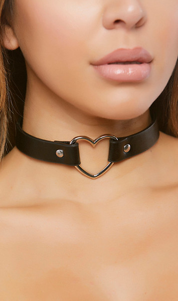 Faux leather choker with metal heart shaped ring and adjustable snap closure. Heart measures about 1-1/2" tall, choker measures about 3/4" wide.