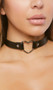 Faux leather choker with metal heart shaped ring and adjustable snap closure. Heart measures about 1-1/2" tall, choker measures about 3/4" wide.