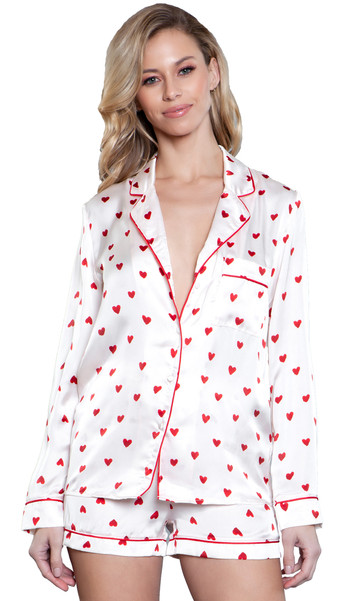 Long sleeve satin pajama set features a heart print long sleeve button up top with collar, left breast pocket and red trim. Matching drawstring shorts with elastic waist.