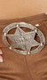 Round belt buckle with SHERIFF star badge in center.